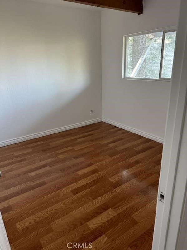 unfurnished room featuring dark hardwood / wood-style flooring