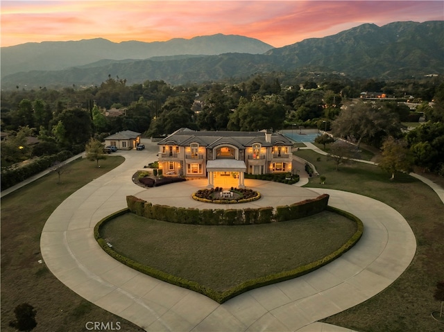 view of home's community featuring a mountain view and a lawn