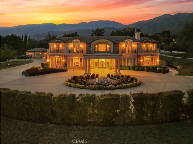 back house at dusk featuring a mountain view