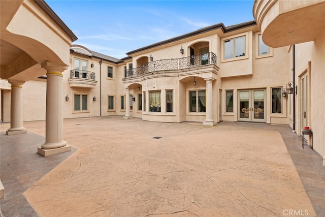 back of house featuring a patio and a balcony