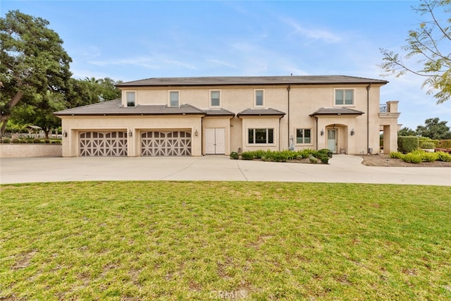 view of front facade featuring a front lawn and a garage