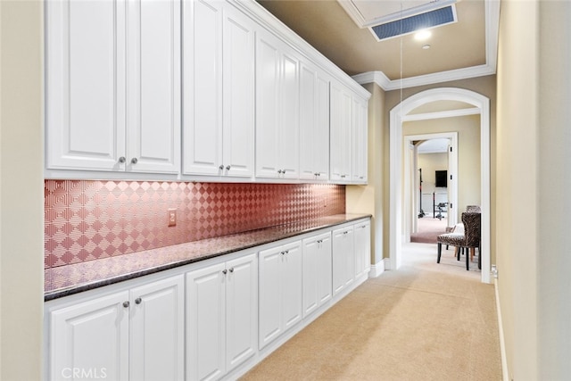 hallway featuring light carpet and ornamental molding