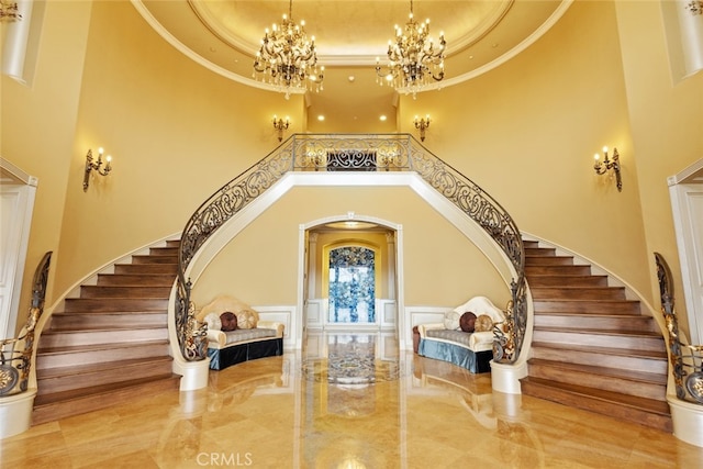 foyer with ornamental molding and a high ceiling