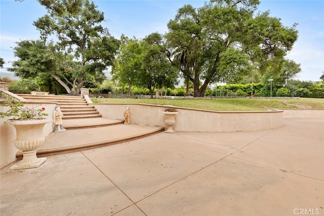 surrounding community with a patio area and a lawn