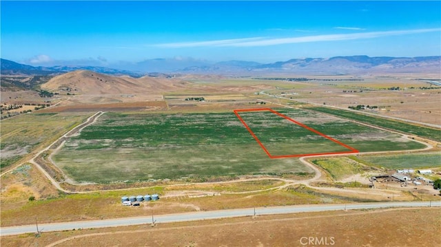 birds eye view of property featuring a mountain view and a rural view