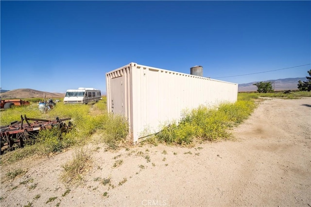 view of side of property with a mountain view