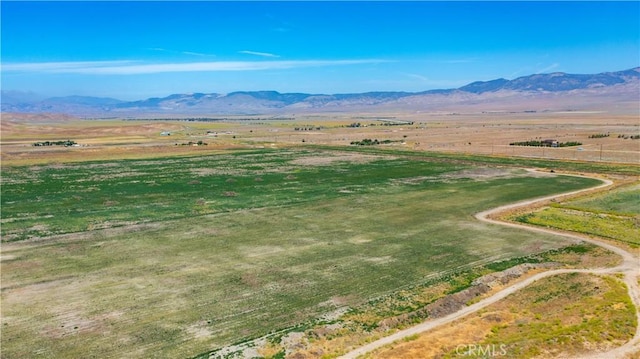 birds eye view of property with a mountain view and a rural view