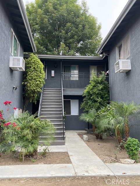 exterior space with a balcony and cooling unit