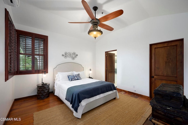 bedroom with ceiling fan, hardwood / wood-style flooring, vaulted ceiling, and an AC wall unit