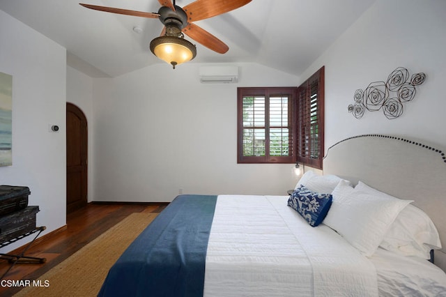 bedroom with ceiling fan, an AC wall unit, vaulted ceiling, and dark hardwood / wood-style floors