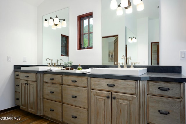 bathroom featuring vanity, lofted ceiling, and hardwood / wood-style floors