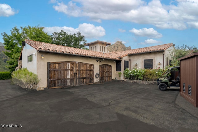 mediterranean / spanish home featuring a garage