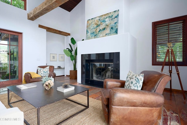 living room featuring high vaulted ceiling, hardwood / wood-style flooring, and beamed ceiling