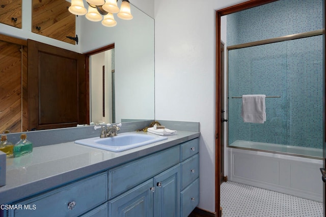 bathroom featuring vanity, enclosed tub / shower combo, and tile patterned floors