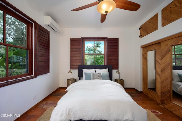 bedroom featuring dark hardwood / wood-style flooring, a wall mounted AC, multiple windows, and ceiling fan