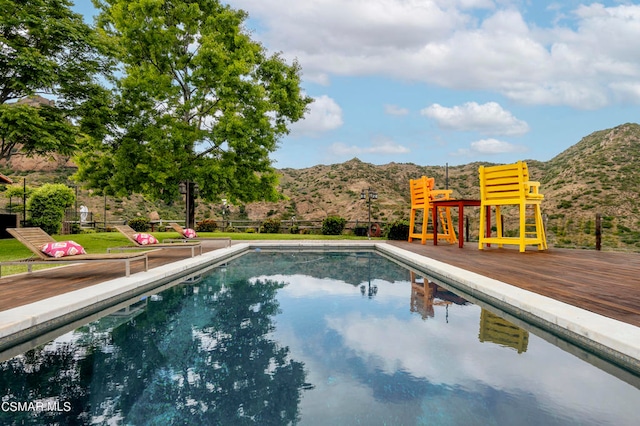 view of pool with a deck with mountain view