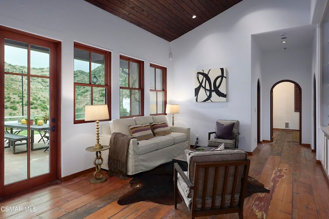 living room featuring hardwood / wood-style floors, wood ceiling, and high vaulted ceiling