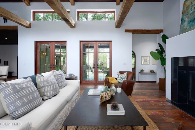 living room featuring french doors, beam ceiling, and a healthy amount of sunlight