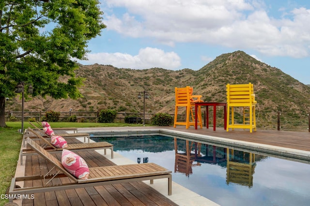 view of swimming pool featuring a deck with mountain view