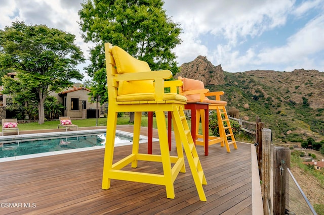 view of play area featuring a pool side deck with mountain view