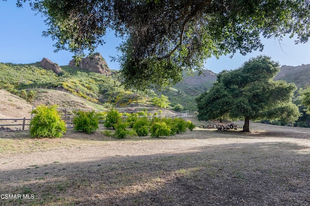 view of yard featuring a rural view and a mountain view