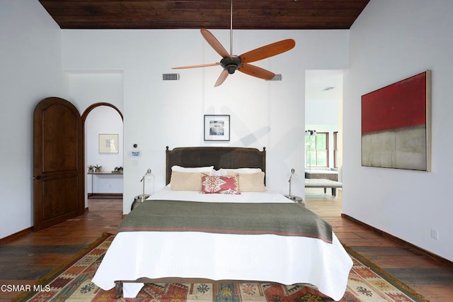 bedroom with ceiling fan, dark hardwood / wood-style flooring, and wood ceiling