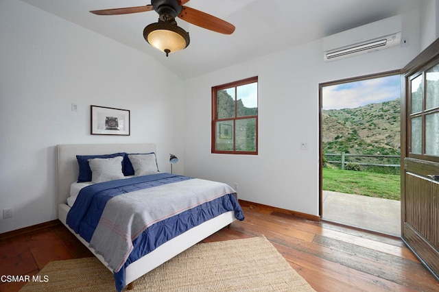 bedroom featuring lofted ceiling, hardwood / wood-style floors, a wall mounted AC, ceiling fan, and access to outside