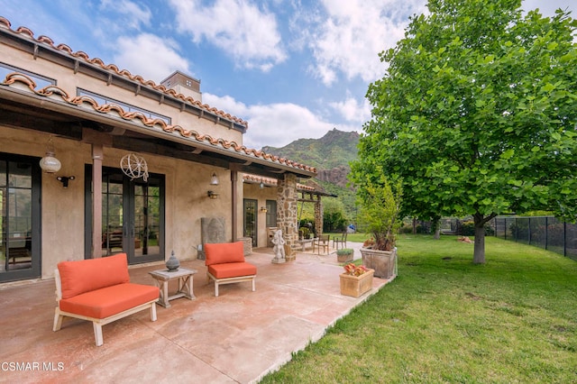 view of yard with a mountain view and a patio