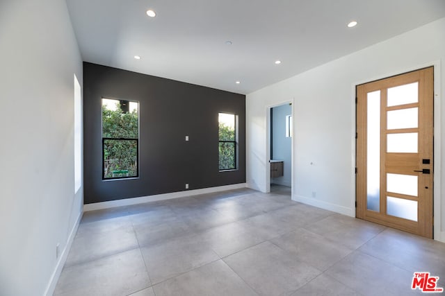 unfurnished room featuring plenty of natural light