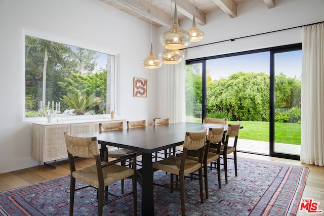 dining area with hardwood / wood-style flooring and beamed ceiling