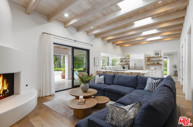 living room featuring wood ceiling, beam ceiling, and light hardwood / wood-style floors