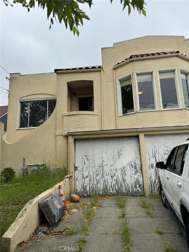 2123 High St, Oakland, CA 94601 - view of front of home featuring stucco siding and an attached garage