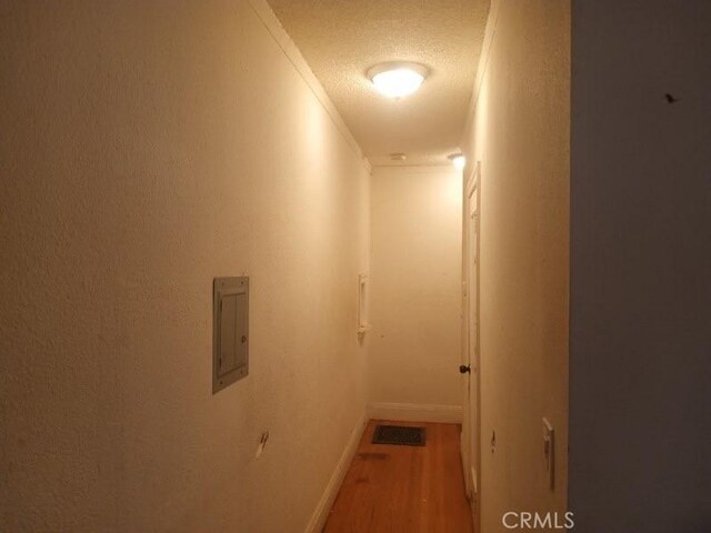2123 High St, Oakland, CA 94601 - hallway with baseboards, a textured ceiling, and wood finished floors