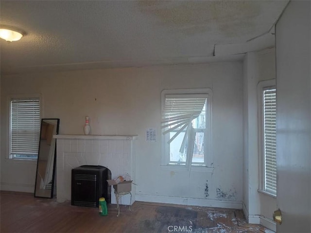 2123 High St, Oakland, CA 94601 - unfurnished living room with wood finished floors, baseboards, and a textured ceiling