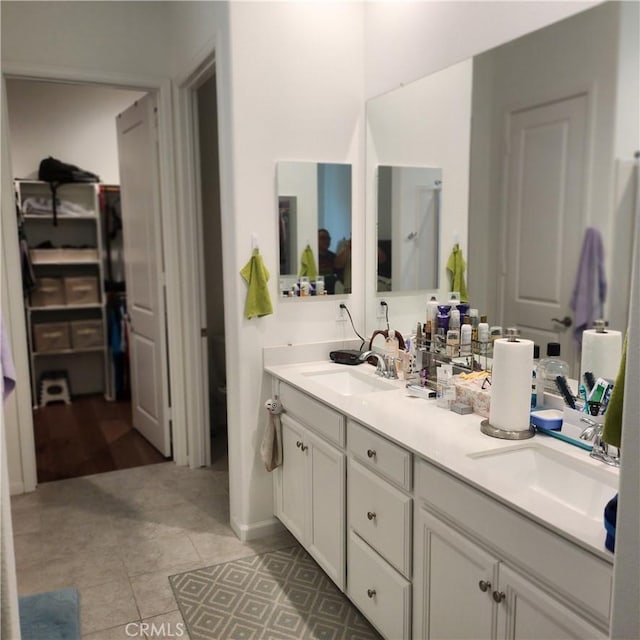 bathroom featuring tile patterned flooring and vanity