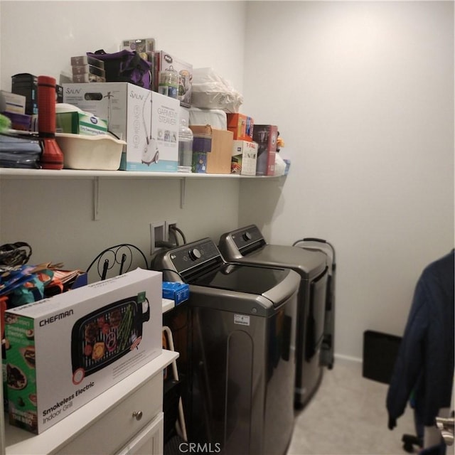 clothes washing area with light colored carpet and washing machine and clothes dryer