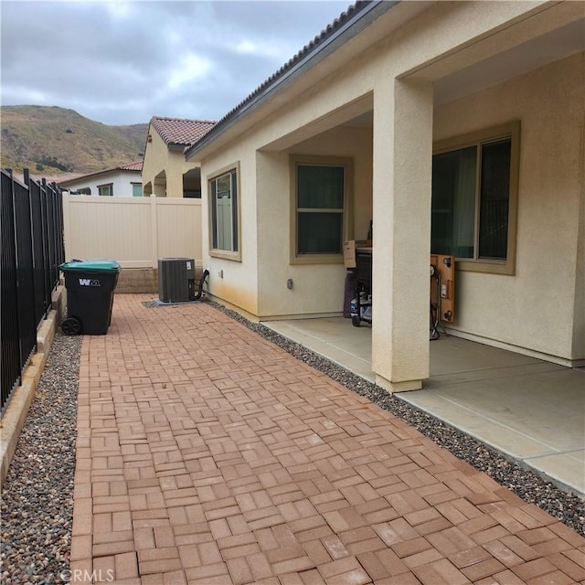 view of patio / terrace with a mountain view and cooling unit