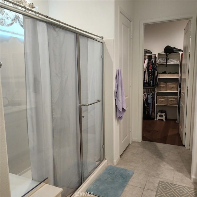 bathroom with tile patterned floors and a shower with shower door