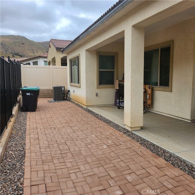 view of patio / terrace featuring a mountain view and cooling unit