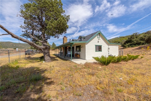 rear view of house featuring a patio and a mountain view