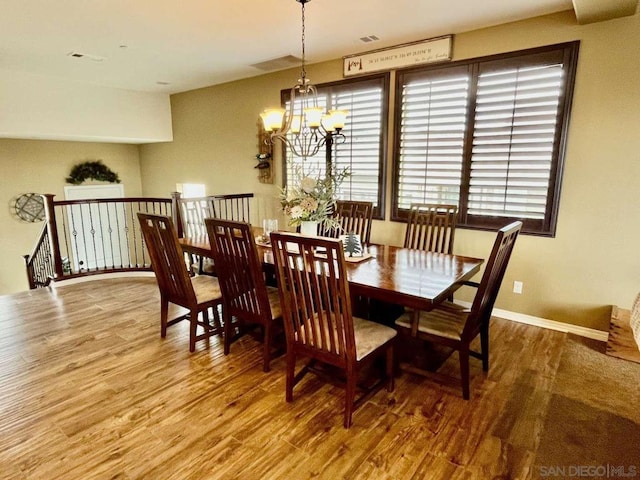 dining area featuring a chandelier and hardwood / wood-style flooring