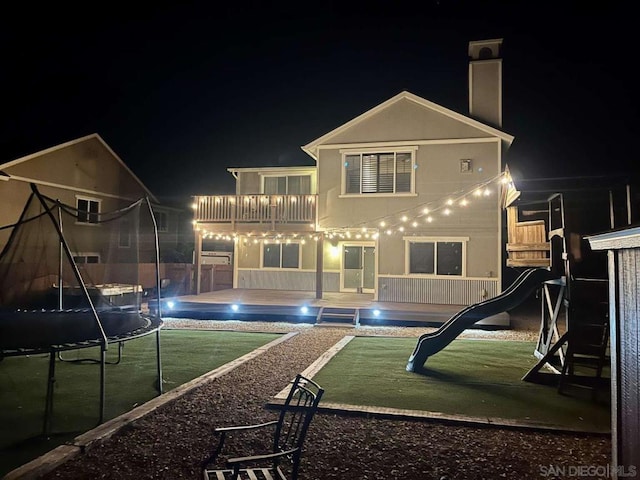 back house at twilight with a trampoline