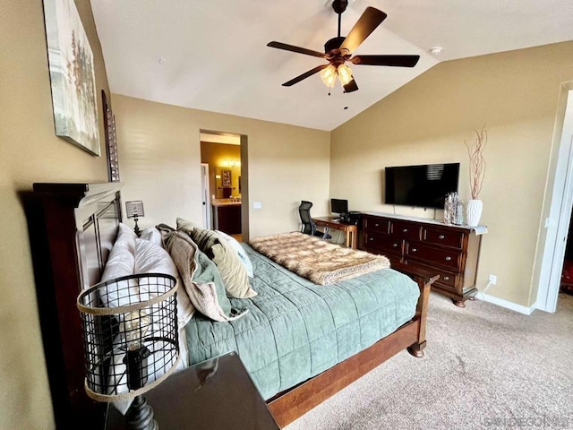 bedroom featuring a fireplace, light carpet, vaulted ceiling, ensuite bathroom, and ceiling fan