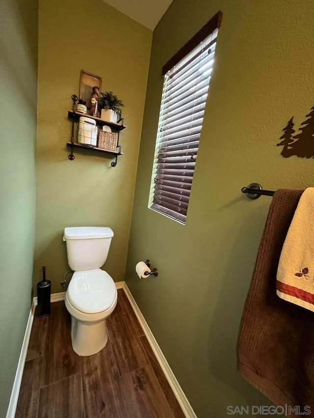 bathroom featuring hardwood / wood-style flooring and toilet