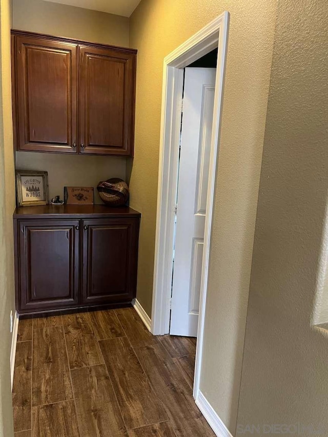 hallway with dark hardwood / wood-style flooring