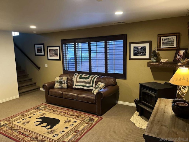 carpeted living room featuring a wood stove