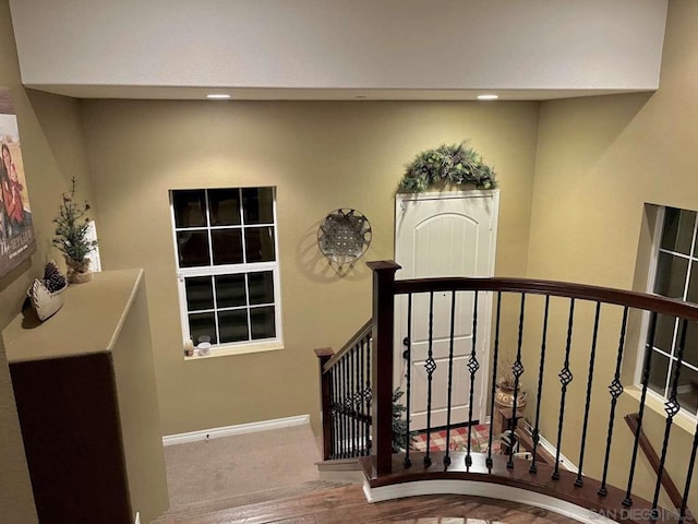 stairs featuring hardwood / wood-style flooring