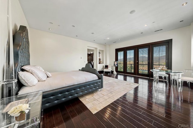 bedroom with french doors and wood-type flooring