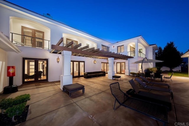 back of property featuring a pergola, a patio area, and french doors