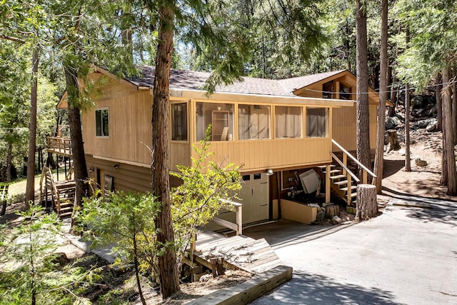 view of front of home featuring a sunroom